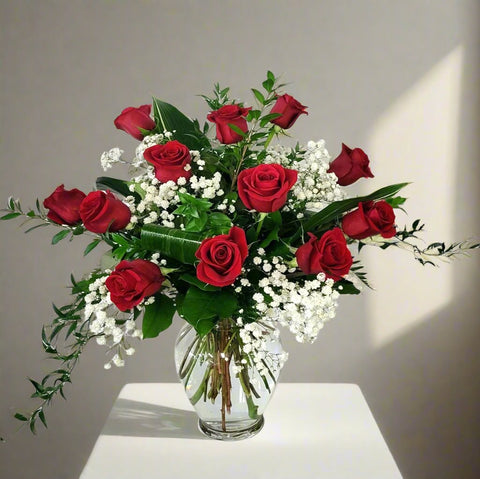 Dozen red roses arranged in a vase